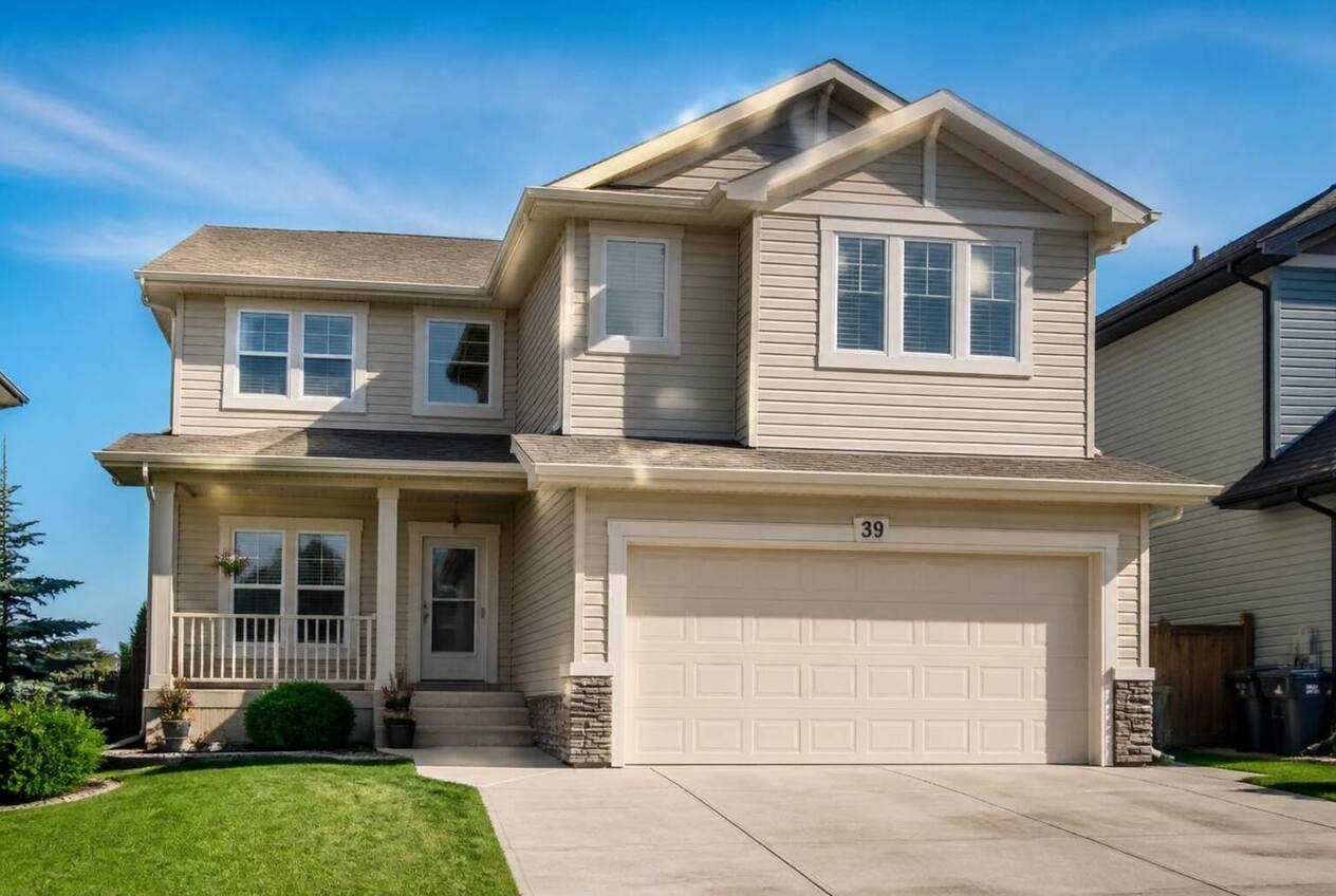 Two-storey Calgary house with beige siding before repainting