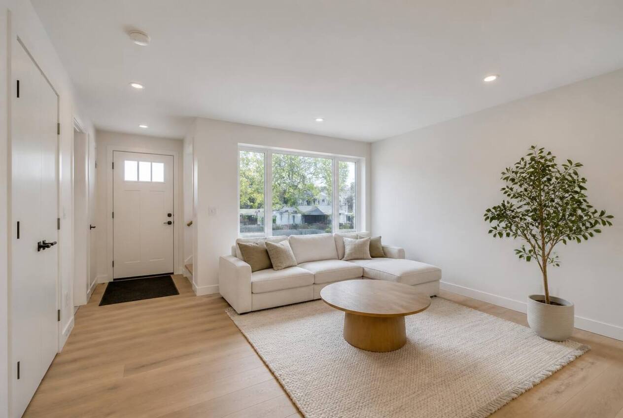 Bright Calgary living room with plain off-white walls before painting